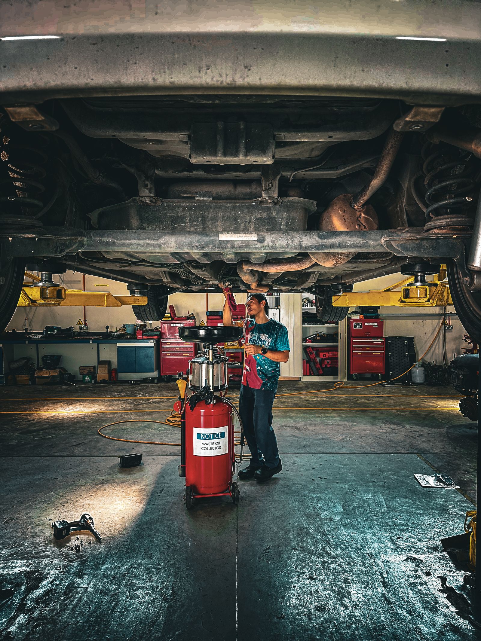 Technician working under the hood of a vehicle